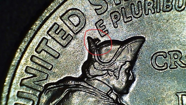 2021 Crossing the Delaware quarter Crown Die Chip error — raised metal bump on Washington's tricorn hat, shown under raking macro light