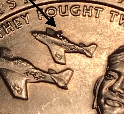 2021 Tuskegee Airmen quarter reverse showing Aircraft Die Chip error near P-51 Mustang wing junction — raised metal creating the 'burning plane' appearance